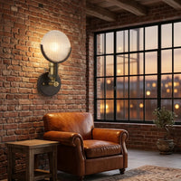 Bronz loft lámpa téglafalon, bőrfotel mellett